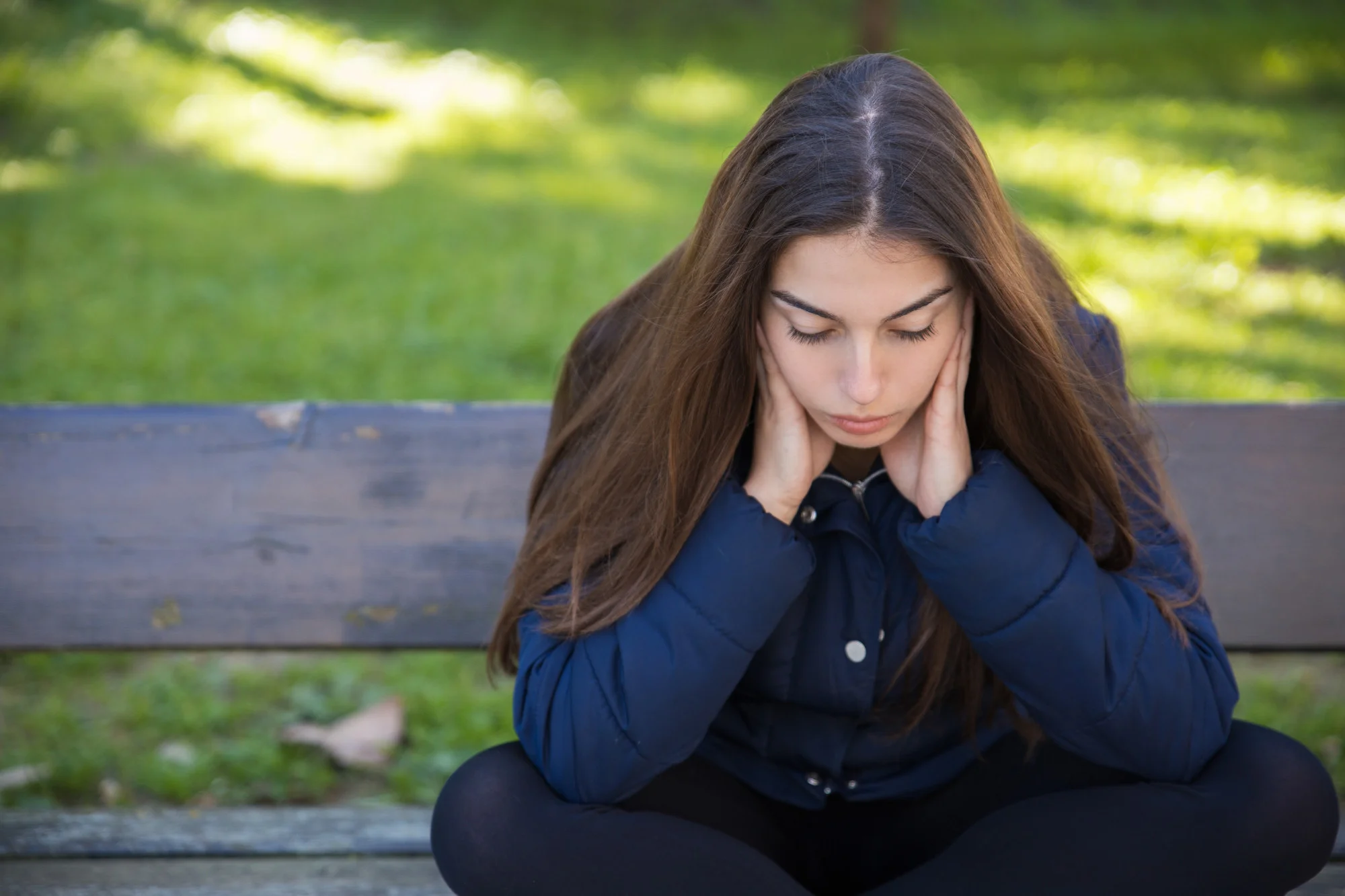 A woman experiencing emotional overwhelm and stress, commonly associated with anxiety, depression, or trauma-related mental health conditions.